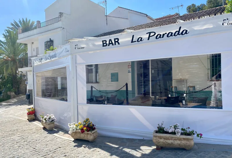 Bar, terraza, flores, paredes blancas.